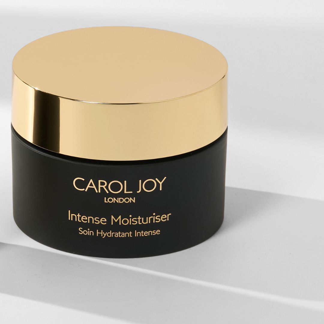 The Carol Joy London Intense Moisturiser on a display stand against a plain white background