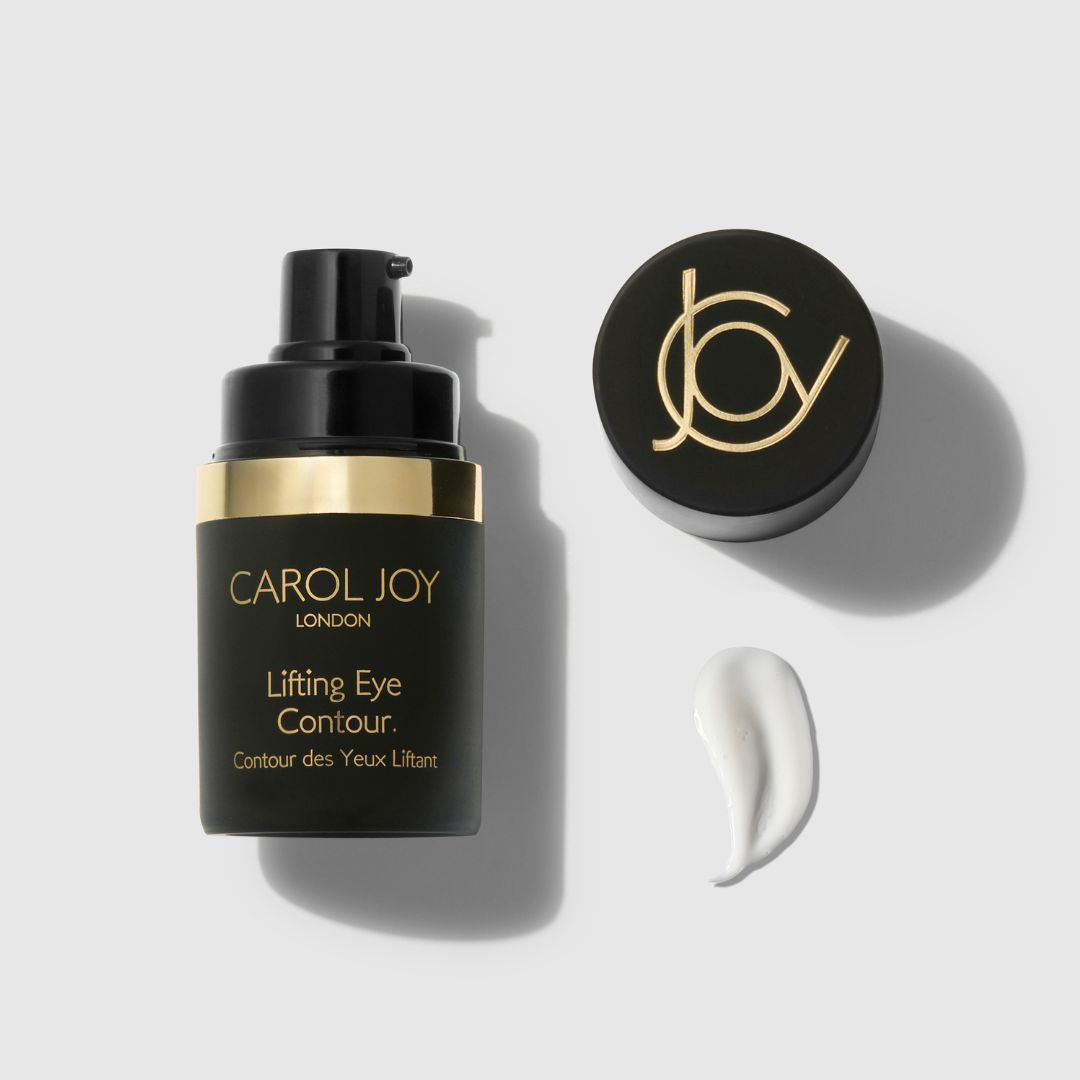 An uncapped Carol Joy London Lifting Eye Contour against a plain white background, its lid and a swatch of the product to the right